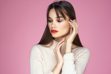 Beautiful brunette red lips white blouse close-up attractive view pink background