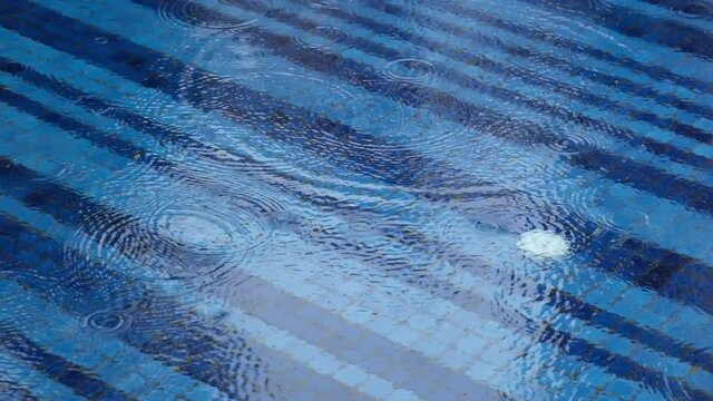 4k Static Footage Of Heavy Rain Falling In An Outside Blue Tiled Swimming Pool