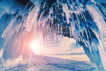 Ice cave on Baikal lake in winter. Blue ice and icicles in the sunset sunlight. Olkhon island, Baikal, Siberia, Russia. Beautiful winter landscape.