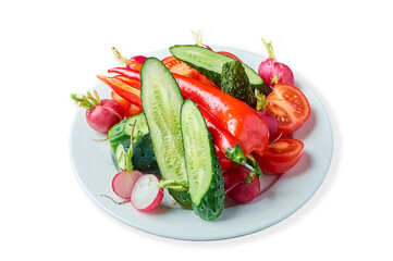 slicing fresh vegetables on a plate on a white background