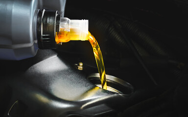 Refueling and pouring oil quality into the engine motor car Transmission and Maintenance Gear .Energy fuel concept.Engine maintenance.                      - obrazy, fototapety, plakaty