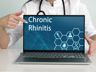  Chronic Rhinitis inscription on the screen. Close up Doctor hands holding black laptop.