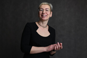 Portrait of caucasian blonde woman wearing glasses on gray background