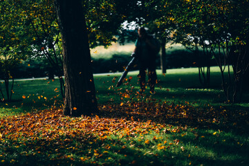 A woman operating a heavy duty leaf blower.