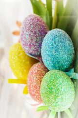 Colorful Easter eggs with tulips. Festive background.