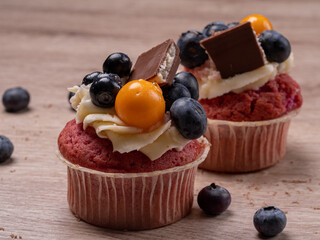 Two homemade fruit muffins with berries and chocolate. Breakfast at home. Photo for culinary courses, printing. High quality photo