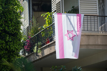 Pink version of the Israeli flag, hanged from a balcony in the city of Tel Aviv, Israel. The pink flag has become the color of the anti-Netanyahu protests 