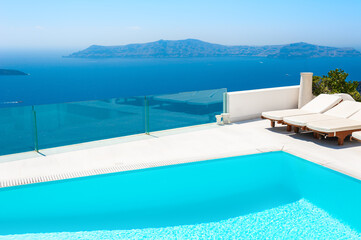 Santorini island, Greece. Luxury swimming pool with sea view. Famous travel destination