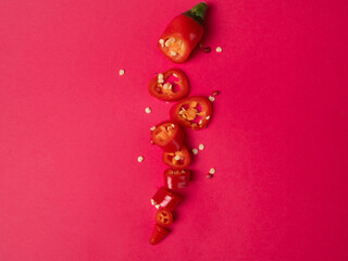 slices of red chili on a dark background, spicy food. Cook at home. Photo for printing. High quality photo