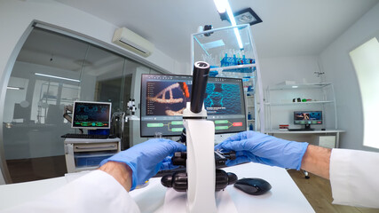 POV of scientists working in lab with patri dish looking into microscope blood analysis. Medical stuff examining vaccine development using high tech researching treatment against covid19 virus