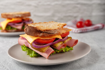 Sandwich with ham, tomatoes, lettuce and yellow cheese