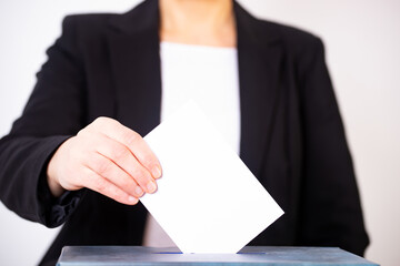 Voter Putting Ballot Into Voting box.