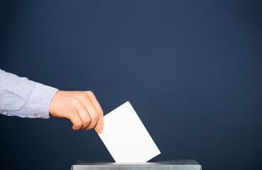 Voter Putting Ballot Into Voting box.