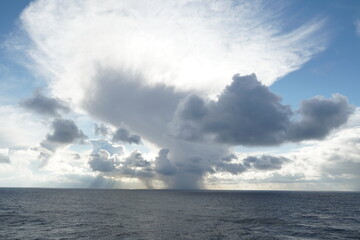 Heavy rainfall clouds bringing abundant rainfall and atmospheric precipitation observed on Pacific ocean.