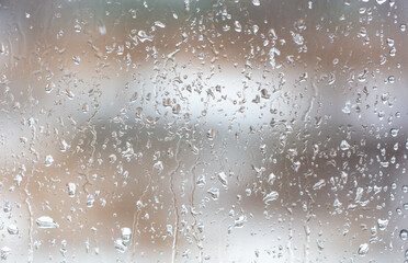 Raindrops on the glass window as a background.