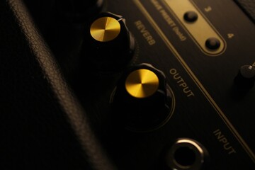 Amplifier knobs on a funky amp which is covered with leather 