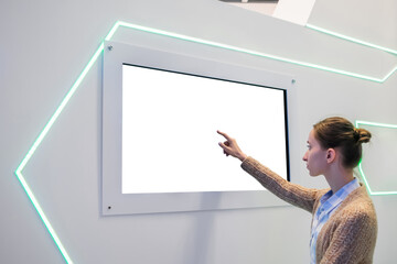 White screen, mock up, future, copyspace, template, technology concept. Woman touching blank digital interactive white display wall at exhibition or museum with futuristic scifi interior