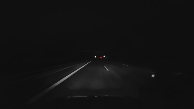 Overtaking a passenger car at a german Autobahn at night. Colorkeying just the red backlights of the car to overtake. Special monochrome eyecatcher with the additional speed ramp effect.