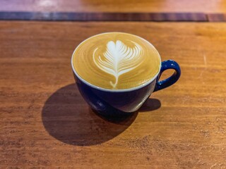 cup of latte on wooden table