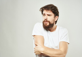 Fototapeta premium The guy gestures with his hands a puzzled look of emotion of bewilderment