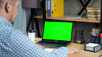 Green screen mock up chroma key display monitor laptop computer concept: Businessman at home office listen company top manager employee online remote conference webcam video call business meeting chat