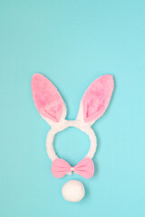 Easter holiday background with pink bunny ears, bow on a blue background