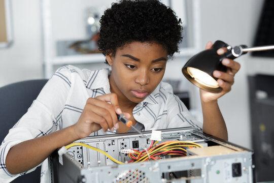 young woman fixing a part of a desktop computer