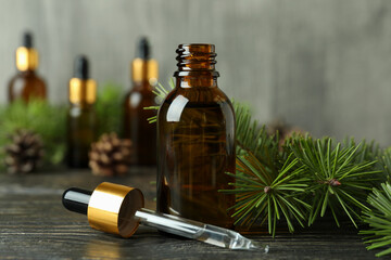 Aromatherapy concept with pine oil on wooden table