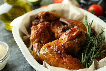 Baking tray with baked chicken wings, close up