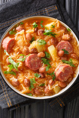 Sauerkraut and Bean Stew Slovenian Jota closeup in the plate on the table. Vertical top view from above