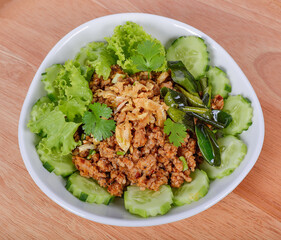 delicious thai food (larb fish) on the wooden floor