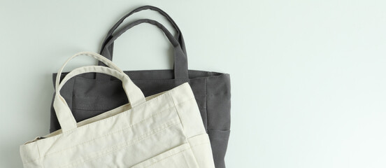 Blank stylish eco bags on white background