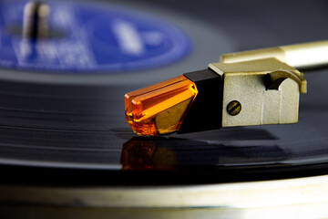 Close up of a turntable acoustic pickup with needle on a vinyl record, selective focus © Robert Knapp