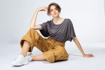 Young white girl on light grey