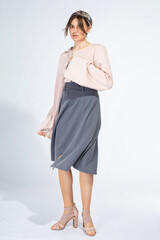 Young white woman isolated on light grey