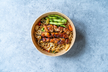 Take Away Japanese Yakitori Chicken with Noodle and Edamame Beans in Take Out Plastic Bowl.