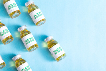 Vials with a new modern medicine for coronavirus on a blue background in the laboratory. Copy space for text, SARS-Cov-2