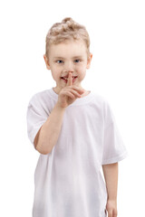 Boy with finger on lips making a silent gesture, isolated on white background
