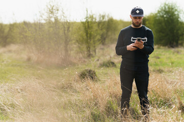 Guy launches a drone in field