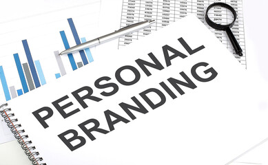 In the notebook, the text Personal Branding , next to magnifier and a pen, the background is graphics.