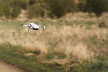 Small drone flies in the field