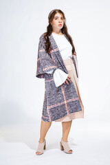 Young white woman isolated on light grey