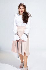 Young white woman isolated on light grey