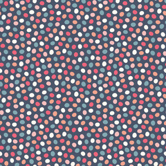 Spotted pattern background. Vector geometric seamless repeat design of hand drawn polka dots in warm colours. 