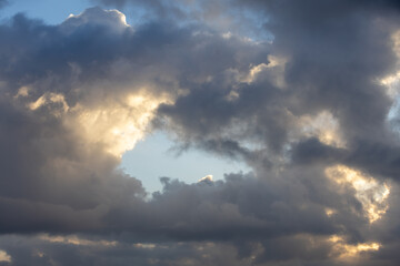 Fototapeta na wymiar Detail of a white cloud in a bright blue sky. Dark rain clouds displace the blue sky. Storm is coming 