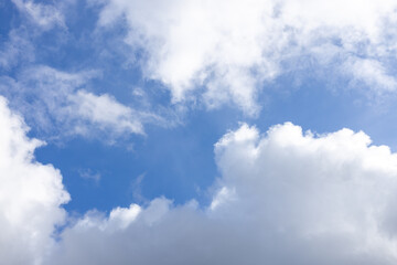 Detail of a white cloud in a bright blue sky. 
Dark rain clouds displace the blue sky. Storm is coming 