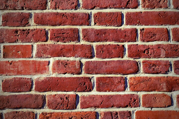 The texture of an old brick wall of red stone. Beautiful background of old masonry historic...