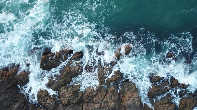 Vista a&eacute;rea din&aacute;mica de olas chocando contra las rocas en la Costa Brava