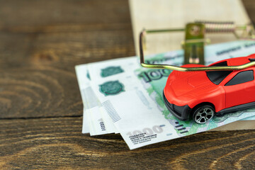 toy car in a mousetrap with money, the concept of a credit trap