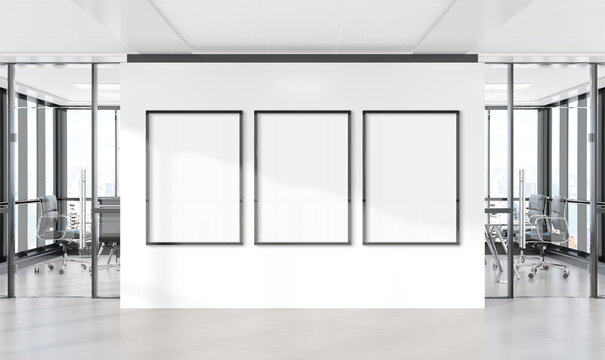 Three vertical frames Mockup hanging on wall. Mock up of billboards in modern concrete office interior 3D rendering